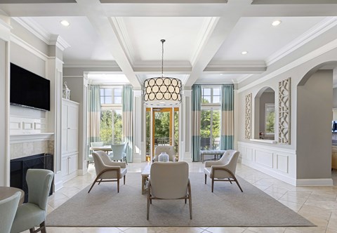a living room with a table and chairs and a fireplace